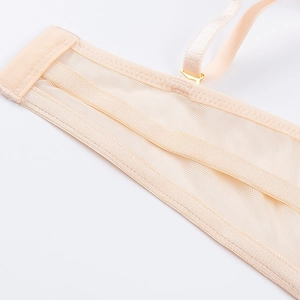Macro shot of breathable mesh fabric and golden metal buckle on a push-up bra side wing