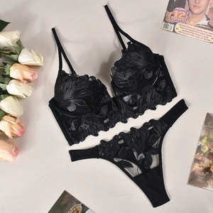 Detailed flat lay of black floral embroidery lace lingerie set with mesh details