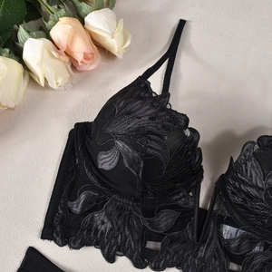 Close-up of exquisite black lace bra featuring floral embroidery and mesh details