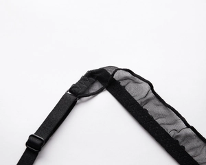 Close-up of black lace mesh fabric with adjustable strap and plastic buckle detail