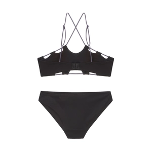 Detail of French-style wireless bra featuring contrast criss-cross back straps and smooth fabric