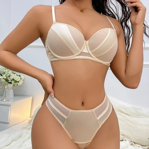 Sultry beige lingerie set featuring push-up bra and high-waist panty on a model