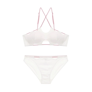 Detail of two-piece white bikini with pink cross-back straps and hollowed-out trim