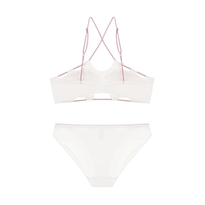 Flat lay of white French style bra set with pink cross back straps and cutout details
