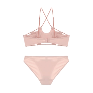 Detail view of pink bra set showing back hook closure and crisscross strap design