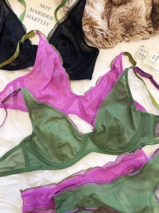 Flat lay of sheer mesh lace lingerie sets in black, purple, and green colors