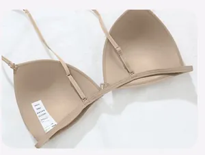 Detail showing seamless back design and thin adjustable straps of a nude color bra