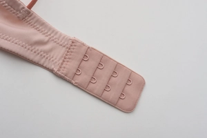 Detail of pink French lace bra showing 4-row 3-hook back closure and wave stitching