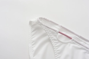 Detailed close-up of white seamless panty with pink straps and refined stitching texture