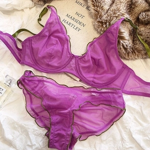 Detailed macro view of purple mesh bra set with green trim and ruffled lace edges