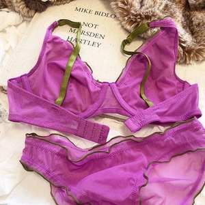 Detailed macro of sheer mesh lace bra set in purple and olive green colors