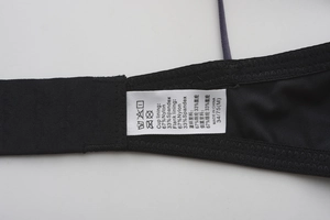 Detail of soft bra side wing with satin care label showing material and wash instructions