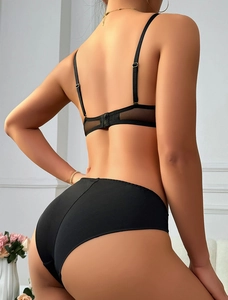 Detail of black lace bra back with mesh stitching and adjustable shoulder straps