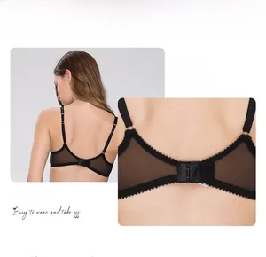 Detail view of black sheer lace bra featuring adjustable straps and double hook-and-eye closure