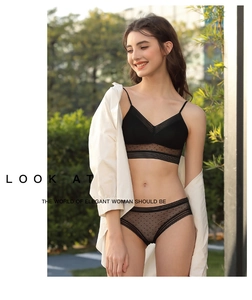 Close-up of black U-shaped backless bra and panties set with mesh polka dot details