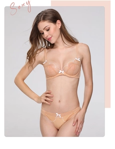 Close-up of peach lace lingerie set featuring scalloped edges and delicate bows