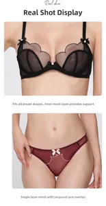 Detail of black mesh bra with bow and burgundy lace panties on model in studio