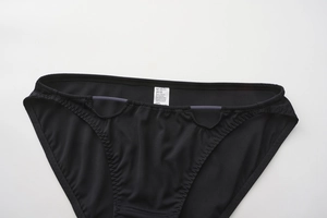 Detail of black seamless panties showing 100% cotton crotch and lace wavy stitching