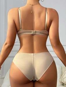 Rear view of seamless beige lace lingerie set featuring thin straps and mesh detail
