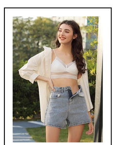 Detail view of white lace bralette with dot mesh texture and transparent stripe band