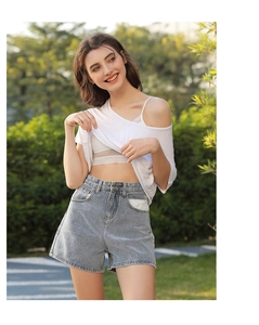 Close-up of French white lace bra with U-back design worn with casual outfit in park