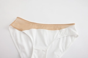 Close-up of seamless white panties featuring sheer mesh splicing and wavy stitching details