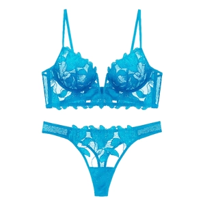 Flat lay of cyan blue sheer leaf embroidery lace bra and matching thong set