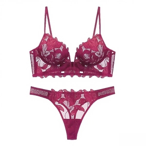 Detailed flat lay of deep burgundy lace lingerie set with V-neck bra and floral thong