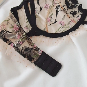 Detailed view of sheer lace floral embroidery bra set with pink flowers and mesh trim