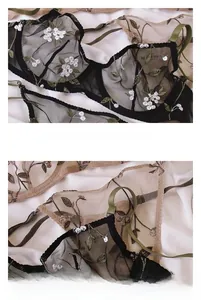 Detailed view of floral embroidery on sheer black mesh bra with green straps