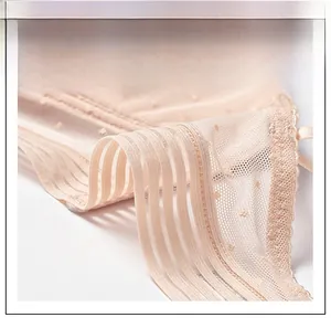 Close-up of breathable mesh side wings with dot embroidery on a French style bra
