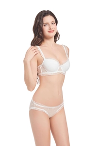 Detail view of white lace bra set with delicate heart embroidery and ruffle straps