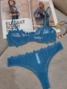 Détail d'un ensemble de lingerie en dentelle bleu foncé avec broderie florale fine