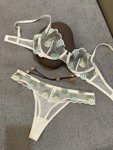 Detailed embroidery of pineapple patterns on white mesh lace lingerie set