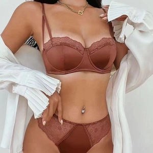 Detail view of caramel brown satin and lace lingerie set with elegant gold jewelry