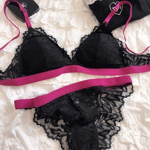 Detail showing black eyelash lace lingerie set with contrast hot pink elastic bands