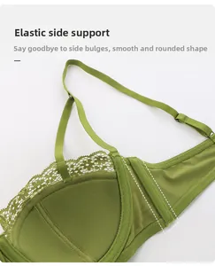 Detail view of the green lace bra's wide elastic side wings and fine mesh lining