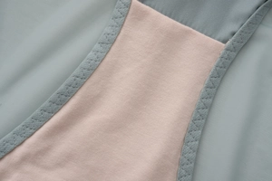 Macro shot of breathable mesh and cotton lining with reinforced V-stitching for lingerie