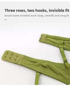 Detail of green lace bra with three-row back closure and adjustable thin straps