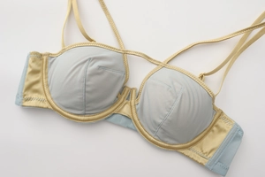Detailed macro view of light blue mesh and silk satin demi cup bra with thin straps