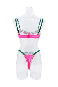Rear view of pink satin lingerie set featuring green straps and floral embroidery details