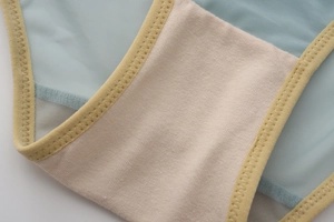 Close-up of light blue mesh fabric with breathable cotton lining and yellow elastic trim