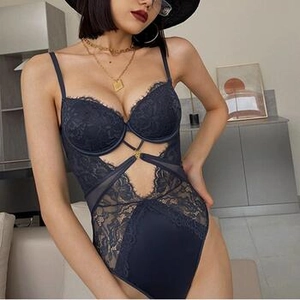 Detail of navy blue lace bodysuit featuring sheer mesh panels and intricate floral patterns