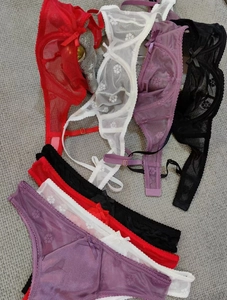 Detailed flat lay of ultra-thin lace lingerie sets in red, white, purple and black colors