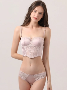 Detail of light purple satin corset top with floral lace patchwork and boning structure