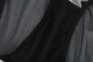 Close-up detail of sheer black lace embroidery and breathable mesh fabric on lingerie