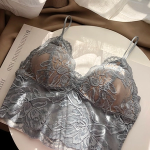 Close-up of grey-blue lace bralette featuring delicate floral patterns and scalloped edges