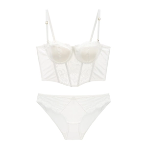 Detailed macro view of delicate white floral lace and mesh texture on luxury corset set