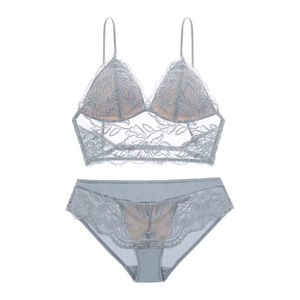 Flat lay of light blue lace lingerie set with triangle bra and matching panties on white