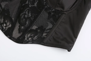 Detail of black lace and satin bustier showing intricate stitching and supportive structure